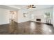 Open living area with herringbone floors, a stone fireplace, and large windows for natural light at 632 Warren Ave, Scottdale, GA 30079