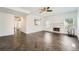 Spacious living room with a fireplace, view into the kitchen, and herringbone wood floors at 632 Warren Ave, Scottdale, GA 30079