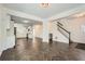 Open-concept living area boasts herringbone floors, white walls, and bright kitchen at 632 Warren Ave, Scottdale, GA 30079