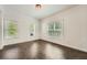Spacious living room featuring three windows and stylish herringbone floors at 632 Warren Ave, Scottdale, GA 30079