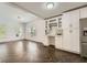 Living area features Herringbone floors, white bar with wine rack, and stainless refrigerator at 632 Warren Ave, Scottdale, GA 30079