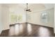 Bright main bedroom with dark wood floors, ceiling fan and large windows for lots of natural light at 632 Warren Ave, Scottdale, GA 30079