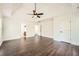 Spacious main bedroom with wood floors, ceiling fan, and entryways into walk-in closet and bathroom at 632 Warren Ave, Scottdale, GA 30079