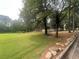 Scenic view of a local park with a playground, mature trees, and open green space for recreational activities at 632 Warren Ave, Scottdale, GA 30079