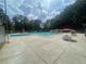 Community swimming pool with lounge chairs and umbrellas, perfect for enjoying sunny days and outdoor recreation at 632 Warren Ave, Scottdale, GA 30079
