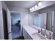 Bathroom with white cabinets and a view into an adjacent bedroom at 125 Leveret Rd, Locust Grove, GA 30248