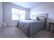 Bright bedroom with a window and comfortable bed for relaxation at 125 Leveret Rd, Locust Grove, GA 30248