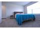 Relaxing bedroom filled with natural light, plush carpet, and a bedside table at 125 Leveret Rd, Locust Grove, GA 30248