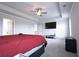 Spacious bedroom with a tray ceiling, a ceiling fan, and a large TV mounted on the wall at 125 Leveret Rd, Locust Grove, GA 30248
