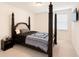 Bedroom with a four-poster bed, neutral walls, and a minimalist design, creating a relaxing and calm atmosphere at 125 Leveret Rd, Locust Grove, GA 30248