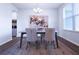 Dining room with a modern chandelier, area rug and elegant chairs at 125 Leveret Rd, Locust Grove, GA 30248
