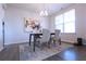 Modern dining room featuring a sleek table, chairs, and elegant chandelier at 125 Leveret Rd, Locust Grove, GA 30248