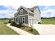 Two-story home with attached garage and partial brick foundation at 125 Leveret Rd, Locust Grove, GA 30248