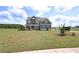 Inviting gray home with a charming front porch and well-manicured lawn at 125 Leveret Rd, Locust Grove, GA 30248