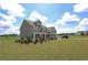 Spacious two-story home features a covered front porch and large front yard at 125 Leveret Rd, Locust Grove, GA 30248