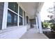 Covered front porch with rocking chairs and brick supports at 125 Leveret Rd, Locust Grove, GA 30248