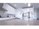 Modern kitchen featuring white cabinets, stainless steel appliances, and a large center island with a sink at 125 Leveret Rd, Locust Grove, GA 30248