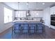 Bright kitchen features white cabinets, stainless steel appliances and a large center island with seating at 125 Leveret Rd, Locust Grove, GA 30248
