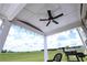 Covered patio with ceiling fan and string lights overlooking a spacious yard at 125 Leveret Rd, Locust Grove, GA 30248