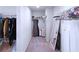 Well-organized walk-in closet featuring ample storage solutions, shelving, and a full-length mirror at 125 Leveret Rd, Locust Grove, GA 30248