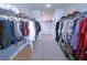 Spacious walk-in closet with ample hanging space and built-in shelving for organized storage at 125 Leveret Rd, Locust Grove, GA 30248