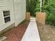 Backyard view of a walkway flanked by wooden fences, leading to an outdoor space at 2257 Rocksram Ct, Buford, GA 30519