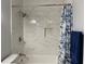 Bathroom features a shower over bath with marbled tile and modern fixtures at 2257 Rocksram Ct, Buford, GA 30519