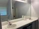 Bathroom featuring dual sinks, a bathtub, and a large mirror with modern fixtures at 2257 Rocksram Ct, Buford, GA 30519