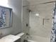 Bathroom features a shower over bath with marbled tile and modern fixtures at 2257 Rocksram Ct, Buford, GA 30519