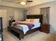 Spacious bedroom featuring a large bed, bedside table, and neutral decor with a ceiling fan at 2257 Rocksram Ct, Buford, GA 30519