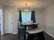 Cozy dining area featuring a modern table and bench seating beneath an elegant light fixture at 2257 Rocksram Ct, Buford, GA 30519