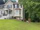 Charming two-story home with a covered porch, bay window, and well-manicured lawn at 2257 Rocksram Ct, Buford, GA 30519
