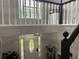 Bright foyer with glass-accented door, hardwood floors, and staircase with white railings at 2257 Rocksram Ct, Buford, GA 30519