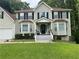 Charming front entrance with covered porch, decorated with plants and seating at 2257 Rocksram Ct, Buford, GA 30519