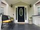 Inviting front porch features seating, plants, and a stylish front door at 2257 Rocksram Ct, Buford, GA 30519