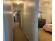 Hallway leading to bedrooms, showcasing neutral paint and carpeted flooring at 2257 Rocksram Ct, Buford, GA 30519