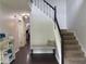 Bright hallway with staircase, dark wood floors, and decorative accents at 2257 Rocksram Ct, Buford, GA 30519