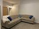 Cozy living room area with a large sectional sofa and neutral decor and carpeting at 2257 Rocksram Ct, Buford, GA 30519