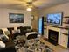 Comfortable living room with plush seating, a fireplace, and a mounted TV at 2257 Rocksram Ct, Buford, GA 30519