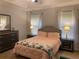 Comfortable main bedroom with soft lighting, tray ceiling, and neutral decor at 2257 Rocksram Ct, Buford, GA 30519