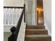 Carpeted stairs with dark wood railing and white balusters lead to the upper level at 2257 Rocksram Ct, Buford, GA 30519