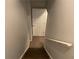 A staircase leading to the upper floor, featuring wooden steps and a white handrail at 2257 Rocksram Ct, Buford, GA 30519