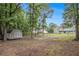 Huge private backyard with grass lawn, storage shed, mature trees, and a partial privacy fence at 4326 Megan Manor Sw Dr, Powder Springs, GA 30127