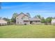 Spacious backyard with a well-maintained lawn, a table, and fencing at 4326 Megan Manor Sw Dr, Powder Springs, GA 30127