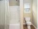 Bathroom with a bathtub, shower, toilet and window at 4326 Megan Manor Sw Dr, Powder Springs, GA 30127