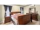 Comfortable bedroom with hardwood furniture, stylish window treatments, and ample natural light at 4326 Megan Manor Sw Dr, Powder Springs, GA 30127