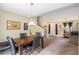 Open-concept dining room features a wood table, four chairs, and flows seamlessly into the living area at 4326 Megan Manor Sw Dr, Powder Springs, GA 30127