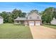 Inviting two-story home with a spacious front lawn and a convenient two-car garage at 4326 Megan Manor Sw Dr, Powder Springs, GA 30127