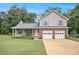 Charming two-story home with a well-manicured lawn, two-car garage, and covered front porch at 4326 Megan Manor Sw Dr, Powder Springs, GA 30127