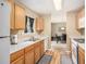 Well-lit kitchen with wooden cabinets and white counter tops adjoins the dining room with matching appliances at 4326 Megan Manor Sw Dr, Powder Springs, GA 30127